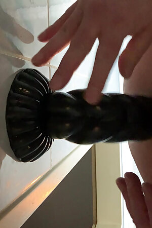 Ass fucking with a dildo on the wall.