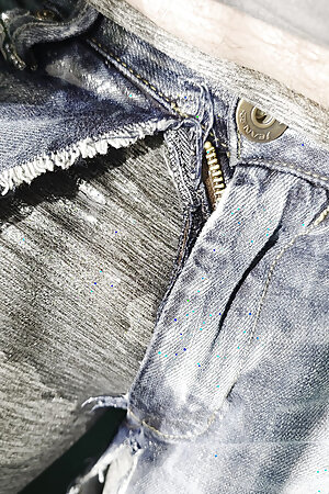 Hammock wetting in gray leggings under tattered jeans