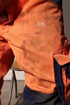 Construction worker squirts on his Hi-Viz worker trousers
