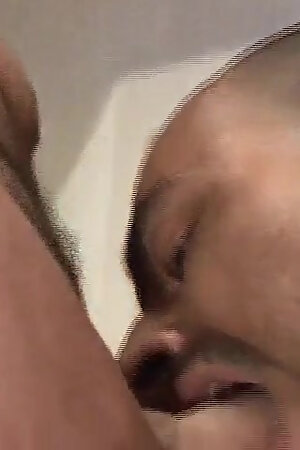 Tattooed man gets his shaved asshole pumped by a younger dude with pierced balls