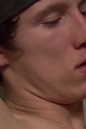 Twink guy blows two big dicks on the couch and licks cum