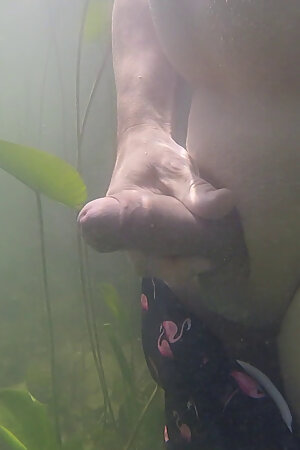 Underwater fun: Gay guy jerks off his foreskin penis in a lake in the mountains.