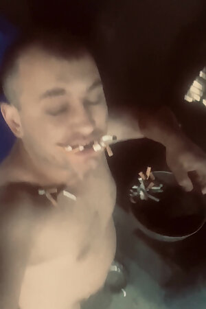 Eats Cigarette Butts and Trash From a Trash Can on the Street