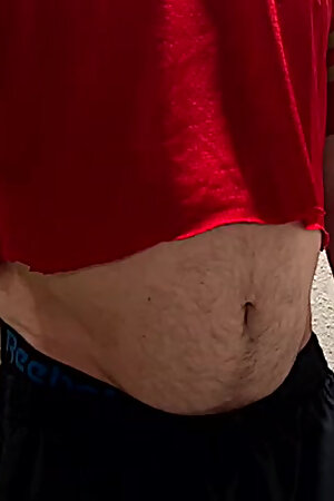 Athlete shows his ball gut and navel