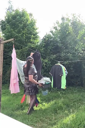 In an outfit with a charcoal colored ruffled dress to gather the laundry.