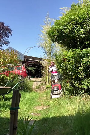 In outfit with a genital cover to mow the lawn.