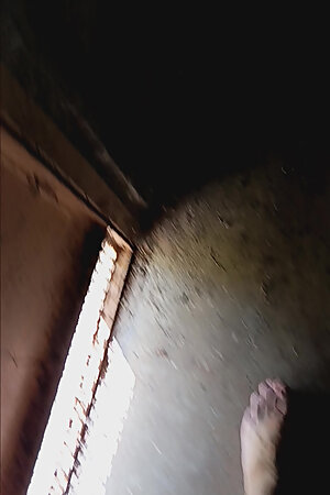 The walks naked in a garage